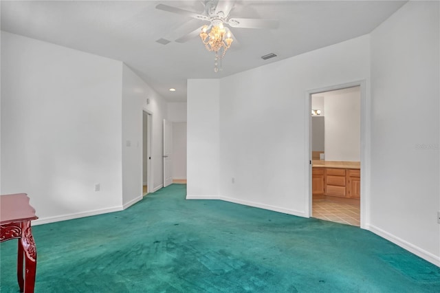 unfurnished bedroom with ceiling fan, light carpet, and ensuite bath