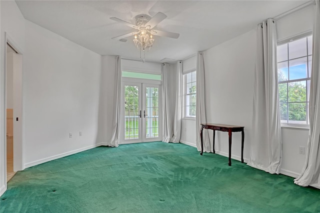 carpeted spare room with french doors and ceiling fan