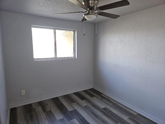 empty room with ceiling fan and dark wood-type flooring