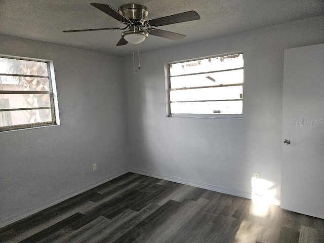 spare room with ceiling fan and dark wood-type flooring