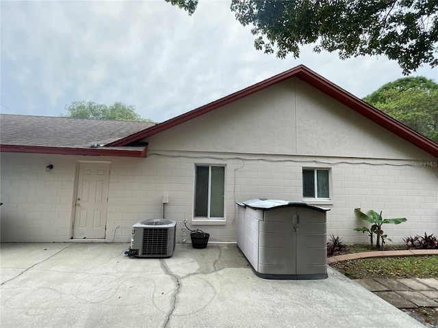 back of house with cooling unit and a patio area