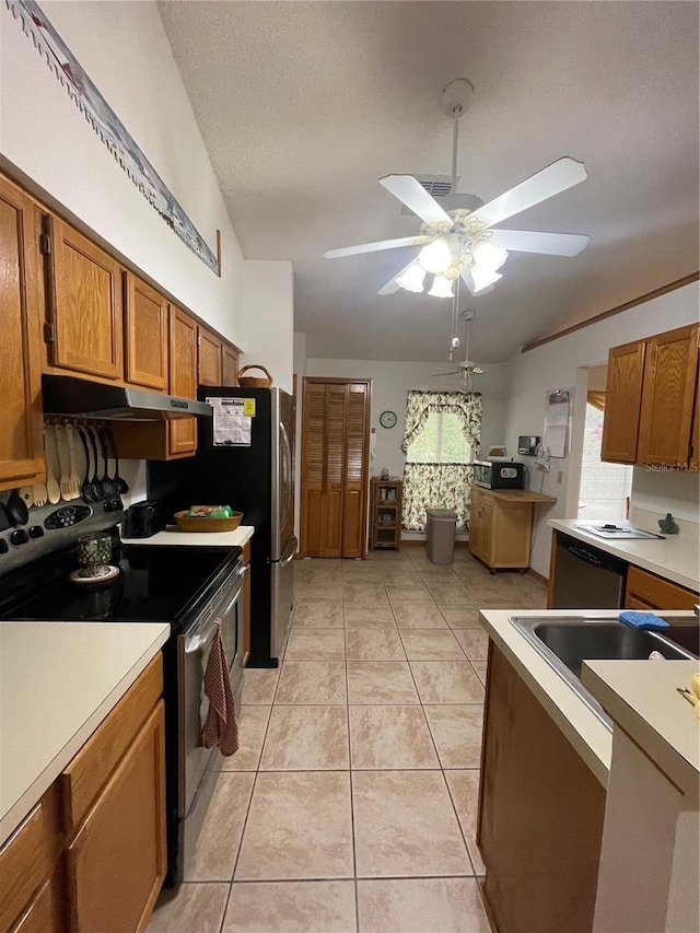 kitchen with stainless steel appliances, light tile patterned flooring, a textured ceiling, and ceiling fan