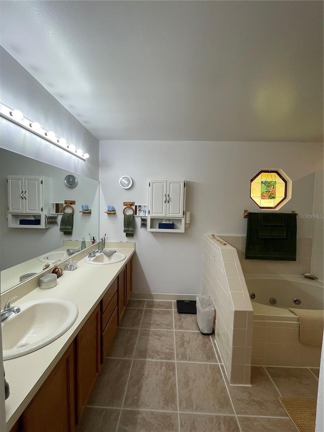 bathroom with vanity, tile patterned flooring, and tiled tub