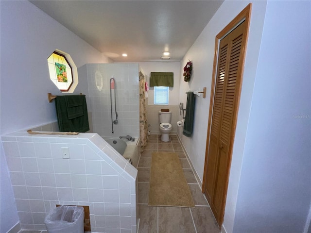 bathroom with shower / tub combo, tile patterned floors, and toilet