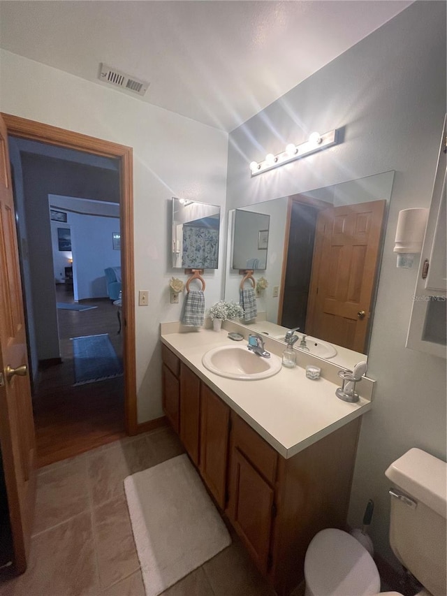 bathroom featuring vanity and toilet