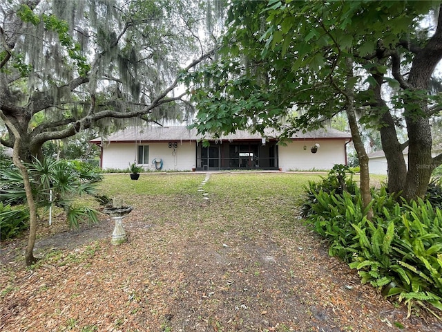 exterior space with a sunroom and a front lawn