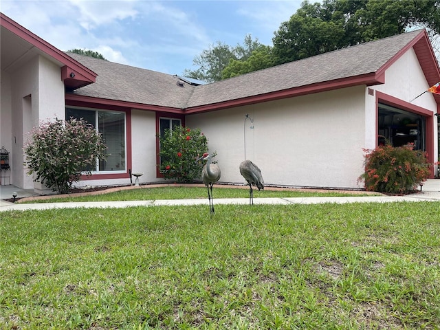 exterior space featuring a garage and a yard