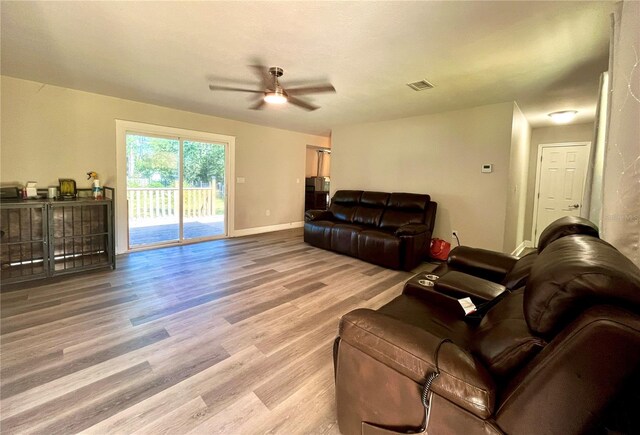 living room with hardwood / wood-style flooring and ceiling fan