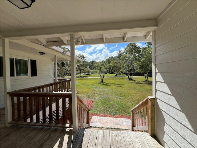 wooden deck featuring a yard