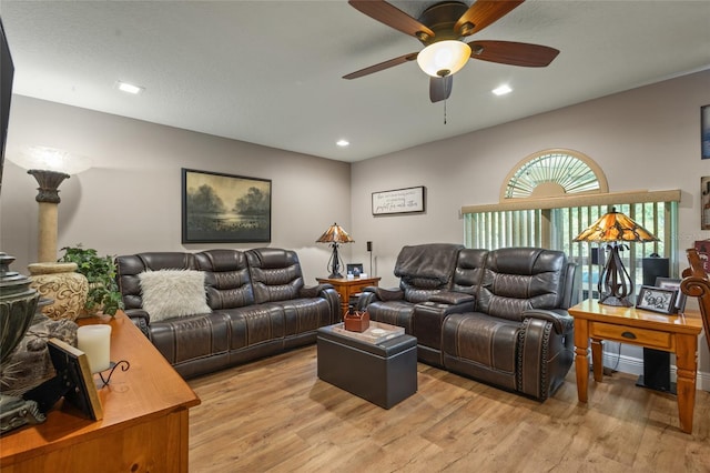 living room featuring ceiling fan and light wood-type flooring