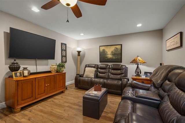 living room featuring ceiling fan and light wood-type flooring