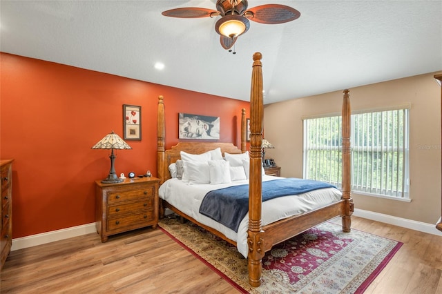 bedroom with ceiling fan, a textured ceiling, and light wood-type flooring