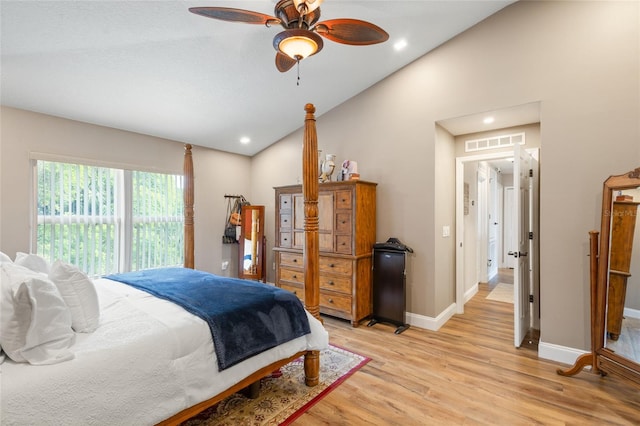 bedroom with ceiling fan, light hardwood / wood-style flooring, and high vaulted ceiling