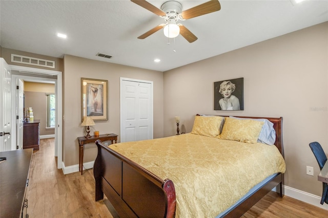 bedroom featuring ceiling fan, light wood-type flooring, and a closet