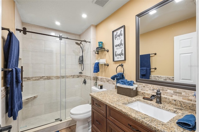 bathroom with walk in shower, backsplash, toilet, and vanity