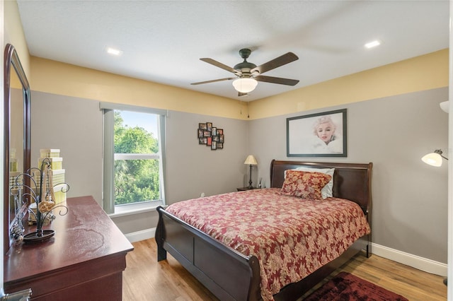 bedroom featuring ceiling fan and light hardwood / wood-style flooring