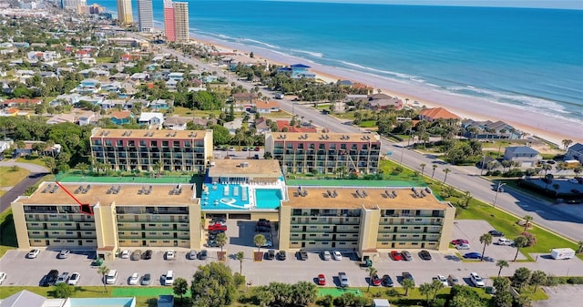 birds eye view of property with a water view and a view of the beach