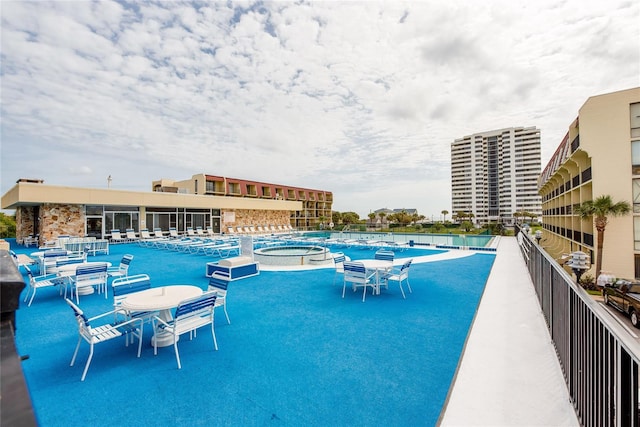 view of pool featuring a hot tub and a patio area