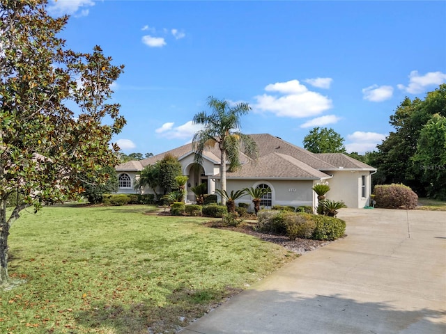 mediterranean / spanish home with a front lawn