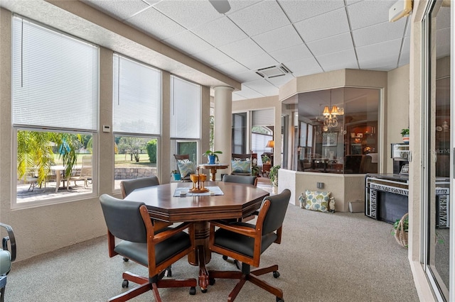 sunroom / solarium with a notable chandelier