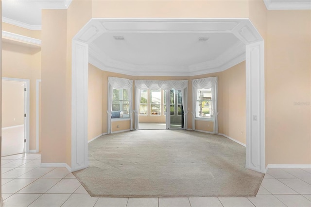 empty room with crown molding and light tile patterned flooring