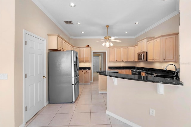 kitchen featuring kitchen peninsula, appliances with stainless steel finishes, crown molding, and sink