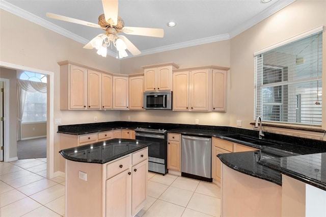 kitchen featuring dark stone countertops, ornamental molding, sink, and appliances with stainless steel finishes