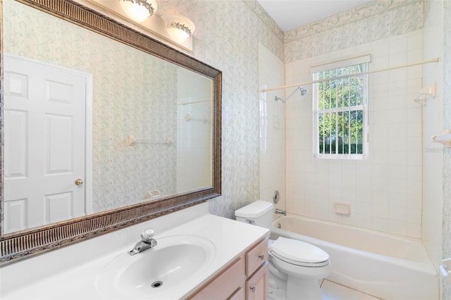 full bathroom featuring vanity, toilet, and tiled shower / bath