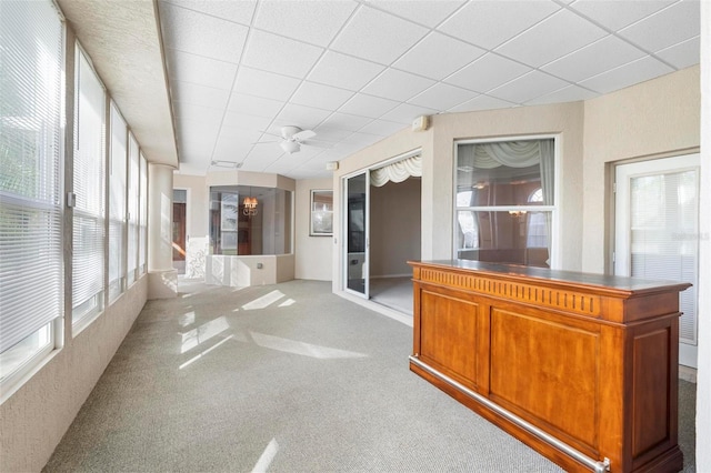 unfurnished sunroom with a wealth of natural light and ceiling fan