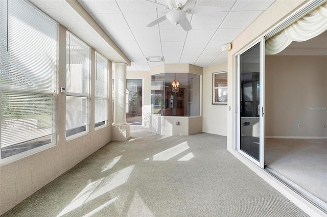 unfurnished sunroom featuring ceiling fan