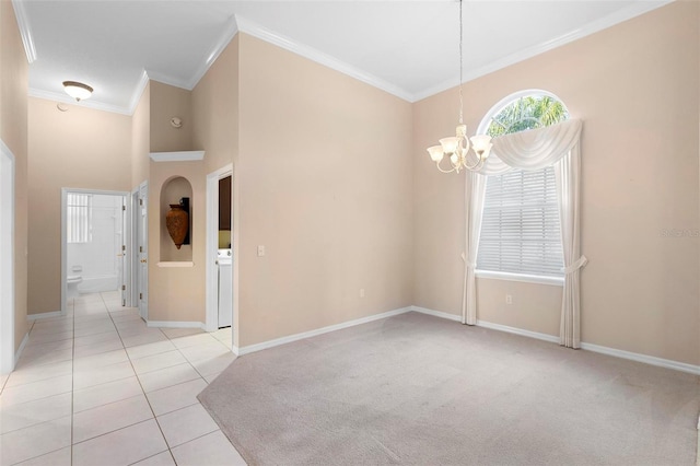 tiled spare room with washer / dryer, crown molding, and a notable chandelier