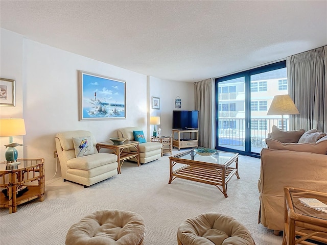 carpeted living room featuring expansive windows and a textured ceiling