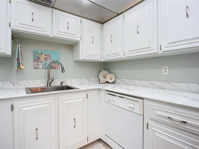 kitchen featuring light tile floors, a textured ceiling, white cabinets, sink, and white dishwasher