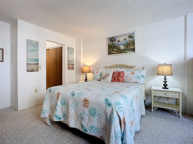 carpeted bedroom featuring a textured ceiling