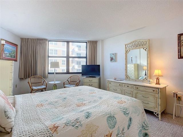 carpeted bedroom with a textured ceiling