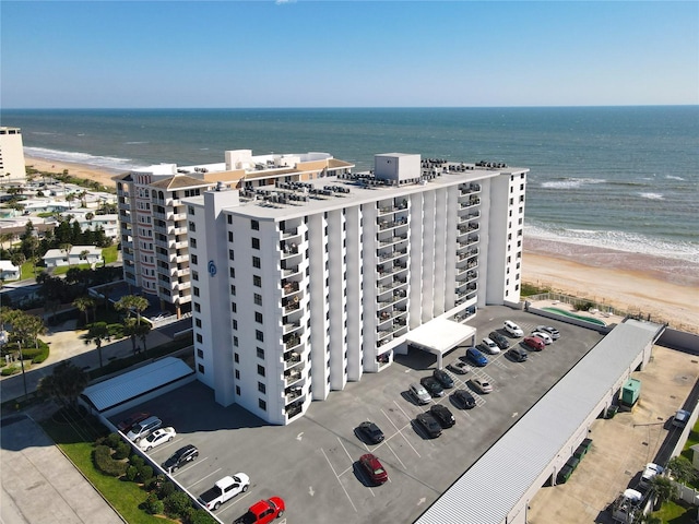 birds eye view of property featuring a beach view and a water view