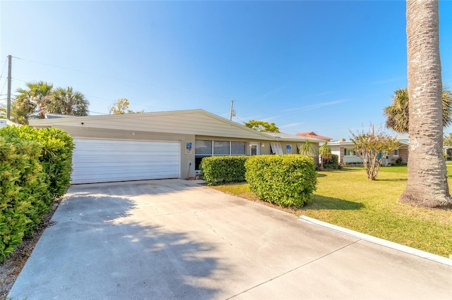 single story home with a front yard and a garage