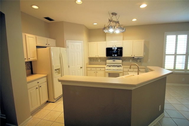 kitchen with tasteful backsplash, decorative light fixtures, white appliances, and light tile floors