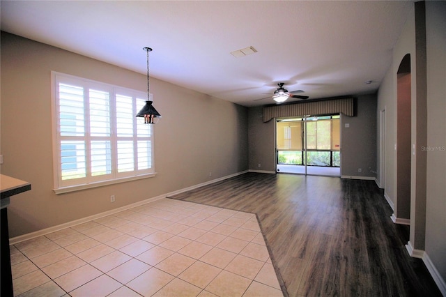 empty room with ceiling fan and tile floors