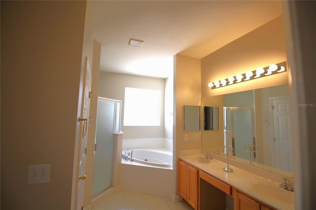 bathroom with a textured ceiling, plus walk in shower, tile floors, and double sink vanity