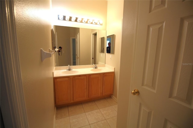 bathroom featuring tile floors and dual vanity