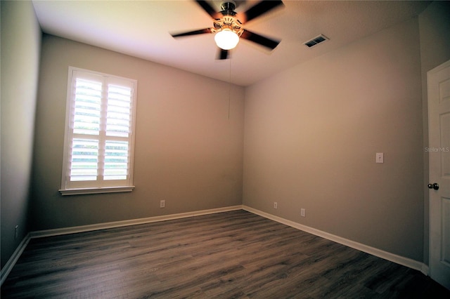 unfurnished room with dark hardwood / wood-style floors, a wealth of natural light, and ceiling fan