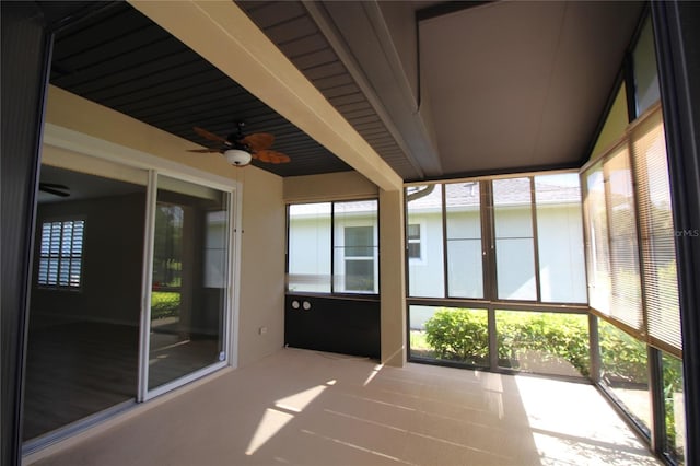 unfurnished sunroom with lofted ceiling and ceiling fan