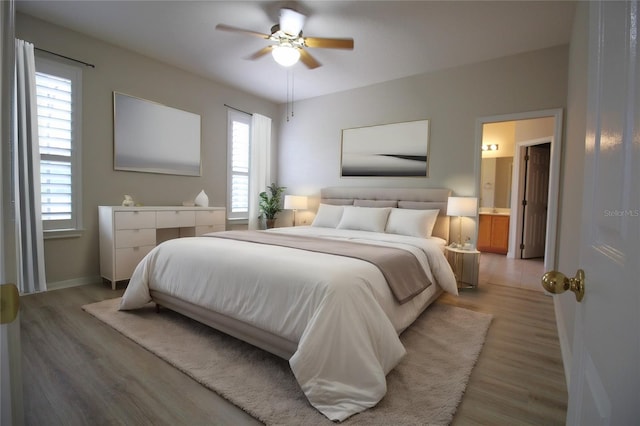 bedroom featuring ensuite bath, ceiling fan, and light hardwood / wood-style floors