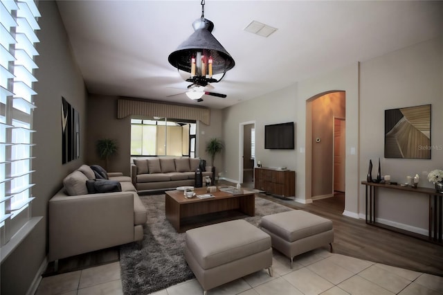 tiled living room with ceiling fan