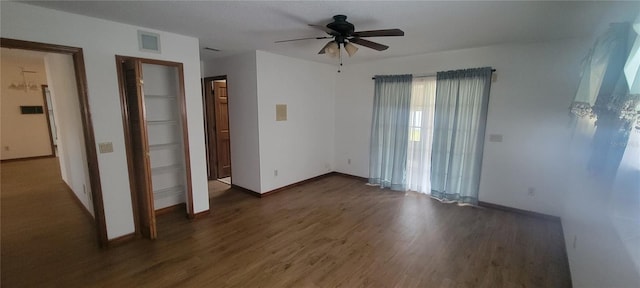 unfurnished bedroom featuring ceiling fan and dark hardwood / wood-style floors