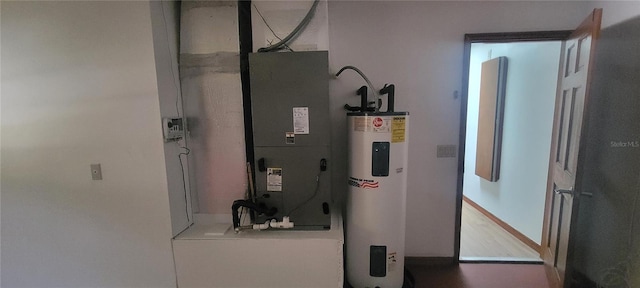 utility room with heating utilities and electric water heater