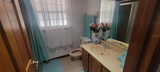 bathroom featuring toilet, tile flooring, and large vanity