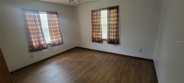 unfurnished room featuring dark wood-type flooring