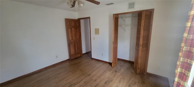 unfurnished bedroom featuring wood-type flooring, ceiling fan, and a closet